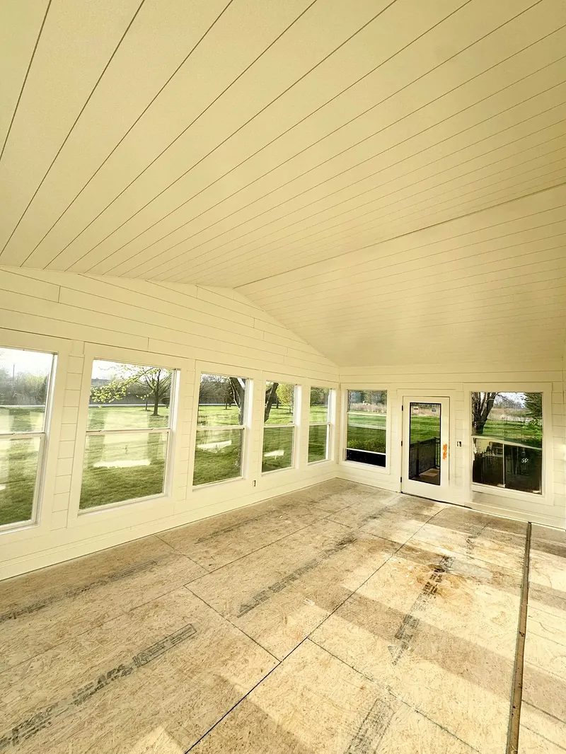 Sunroom with white tongue-and-groove walls and vaulted ceiling freshly painted in Adel
